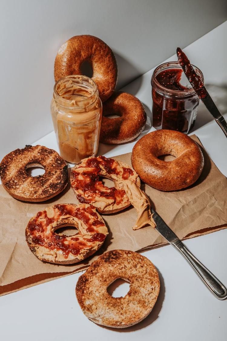 Bagels Recipe - Peanut Butter and Raspberry Jam Spread on Toasted Bagels